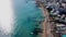 Drone video of beach with blue umbrellas near crystal sea