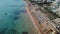 Drone video of beach with blue umbrellas near crystal sea