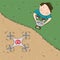 Drone video camera image - young boy controlling his drone, standing on the ground, drone is in the air