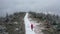 Drone video a female runner runs on a mountain trail in a winter landscape.