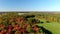 Drone video flying backward over the Nature Park in St-Eustache revealing the beauty of Fall with colorfull trees