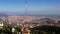 Drone video of a vertical ascent over tibidabo with spectacular panorama over barcelona during the day