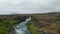 Drone view amazing wild countryside in Iceland, with river flowing in rocky formation riverbed. Aerial view landscape of