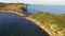 Drone view of a beautiful peninsula Tobizina with vertical cliffs at sunset.