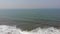 Drone view of beautiful seamless never ending footage while sea waves breaking on sandy coastline Arambol Goa, India Asia