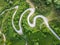 Drone view of beautiful serpentine road leading through mountain landscape