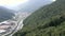 Drone view cable car cabin moving in mountain summer forest among green trees.