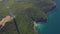 Drone view. Cable cars moving on aerial tramway crossing the ocean and mountains