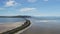 Drone view of a car driving on a long road across Great Salt Lake, Utah, USA