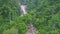 Drone View Cascade Runs into River Hides behind Jungle Trees