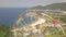 Drone view colorful ferris wheel in amusement park on sea and mountain landscape. Amusement park with large ferris wheel