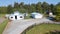 Drone view of the farm yard with barn, garage.