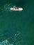 Drone view of female surfer paddling alone