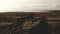 Drone view : Flying over barren land in Iceland, lake in the distance.