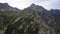 Drone view of a green gorge with high rocky cliffs