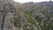 Drone view of a green gorge with high rocky cliffs