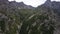 Drone view of a green gorge with high rocky cliffs