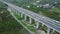 Drone view of highway viaduct over valley, mountains. Showcases infrastructure, mountain infrastructure, agricultural