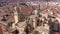 Drone view of historic area of Spanish city of Salamanca with brownish tiled roofs of old houses, gothic building with
