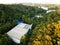 Drone view of a houses in the middle of a dense forest near the skyscrapers of Honolulu, Hawaii