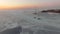 Drone view of the ice-bound strait with two tugboats operating at sunset