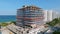 Drone view of large construction site for one more new hotel complex with large panoramic windows located along seashore