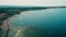 Drone view long coast line on wild sea beach. Sea water splash on rocky coast