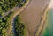 Drone view looking down at the complex network of mangrove roots and tidal waterways at sunset. AI generated.