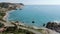 Drone view of Mediterranean lagoon between rocky hills on Cyprus. Aerial view of calm sea waters rolling on pebble beach