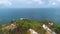 Drone view of Menganti Beach, Kebumen, Indonesia, beautiful beach with white sand, calm waves, coral cliffs and green trees