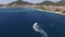 Drone view of a motor boat sailing on the sea to the coast of Budva