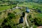 Drone view of an old wooden church and a modern white church in a small village in Maramures