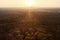 Drone view over forest and trees and an industrial area during the sunset in the ruhr area in Germany