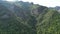 Drone view over forested mountains in the daytime