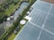 Drone view of a part of a huge commercial glass house growing young plants.