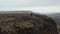 Drone view people hikers standing top cliff looking stunning panorama in Iceland. Aerial view two tourist contemplating