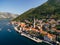 Drone view of the Perast coast with ancient houses and a tower. Montenegro