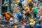 Drone view photo of group of men in workwear and helmets are collecting and sorting garbage. Waste recycling plant, sorting, dirty