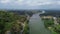 Drone view of the road between green forests and the Serayu river in Indonesia