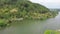 Drone view of the road between green forests and the Serayu river in Indonesia