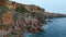 Drone view rocky seaside scenery. Serene sea waves breaking coastline cliffs