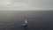 Drone view sail yacht sailing in blue sea on cloudy skyline background