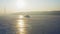 Drone view of the silhouette of an icebreaker anchored among the ice at dawn