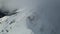 Drone view of the slopes of the Black Pyramid mountain in winter covered in snow