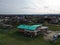 Drone view of the small district with many houses on the green grass in the daytime