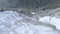 Drone view snowboarder riding freeride on powder snowy field hills in winter mountain on forest landscape. Aerial view snowboarder