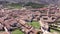 Drone view of Spanish town of El Burgo de Osma in spring overlooking traditional terracotta tiled roofs of residential