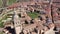 Drone view of Spanish town of El Burgo de Osma in spring overlooking traditional terracotta tiled roofs of residential