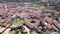 Drone view of Spanish town of El Burgo de Osma in spring overlooking traditional terracotta tiled roofs of residential