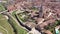 Drone view of Spanish town of El Burgo de Osma in spring overlooking traditional terracotta tiled roofs of residential